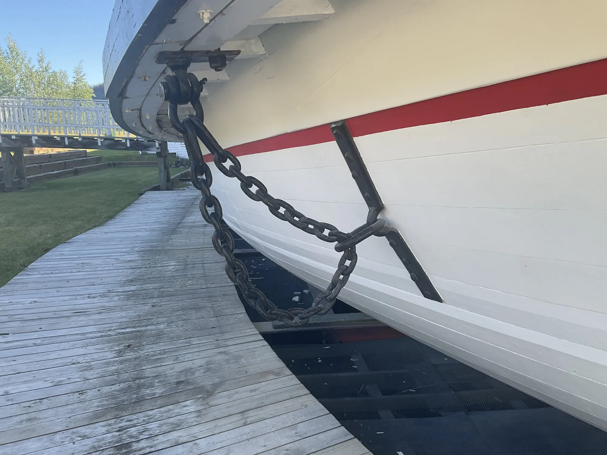 Anchor chain running from the bow down to the ground beside the boardwalk