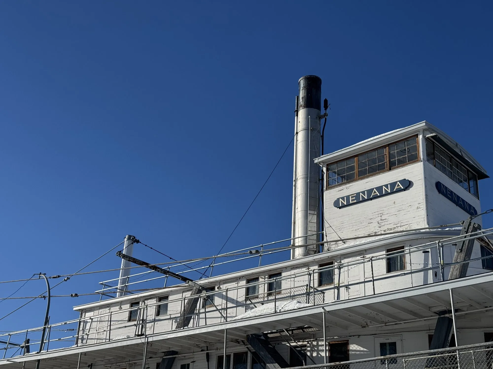 Pilothouse with the name board and the tall stack, seen from below