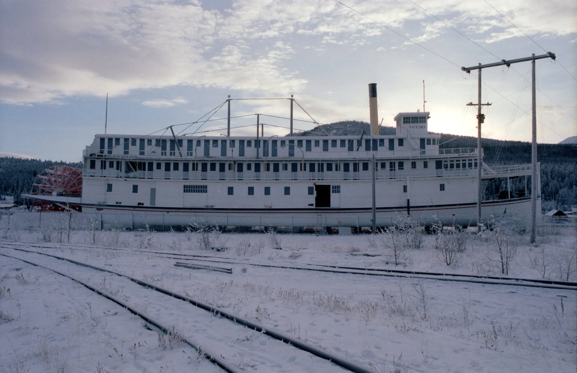 Broadside on shore in winter, railway track in the foreground